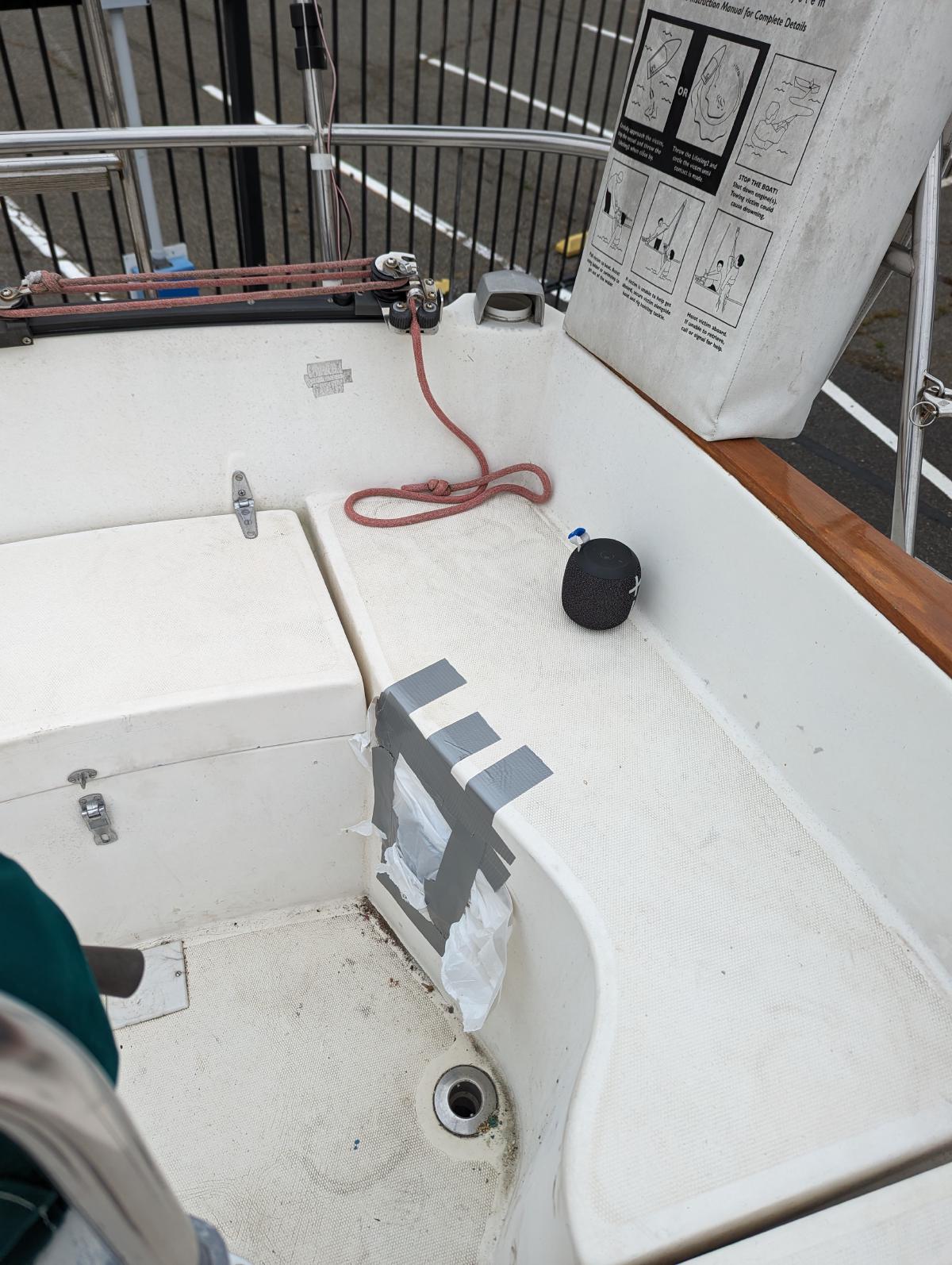 Trash bags covering the hole where the manual bilge pump is stuck.